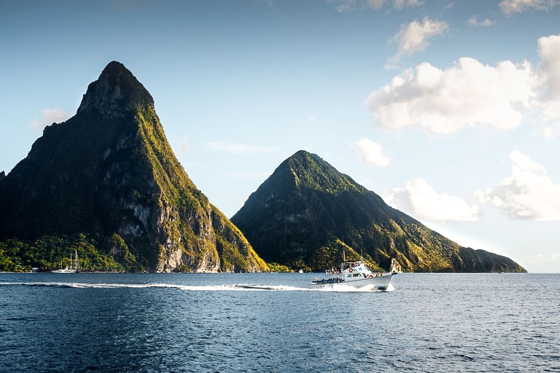 Boat passing in front of the Pitons in Saint Lucia